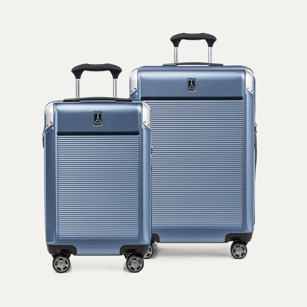 Two blue suitcases with black handles and wheel on a white background