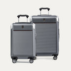 Two gray suitcases with black handles on a white background