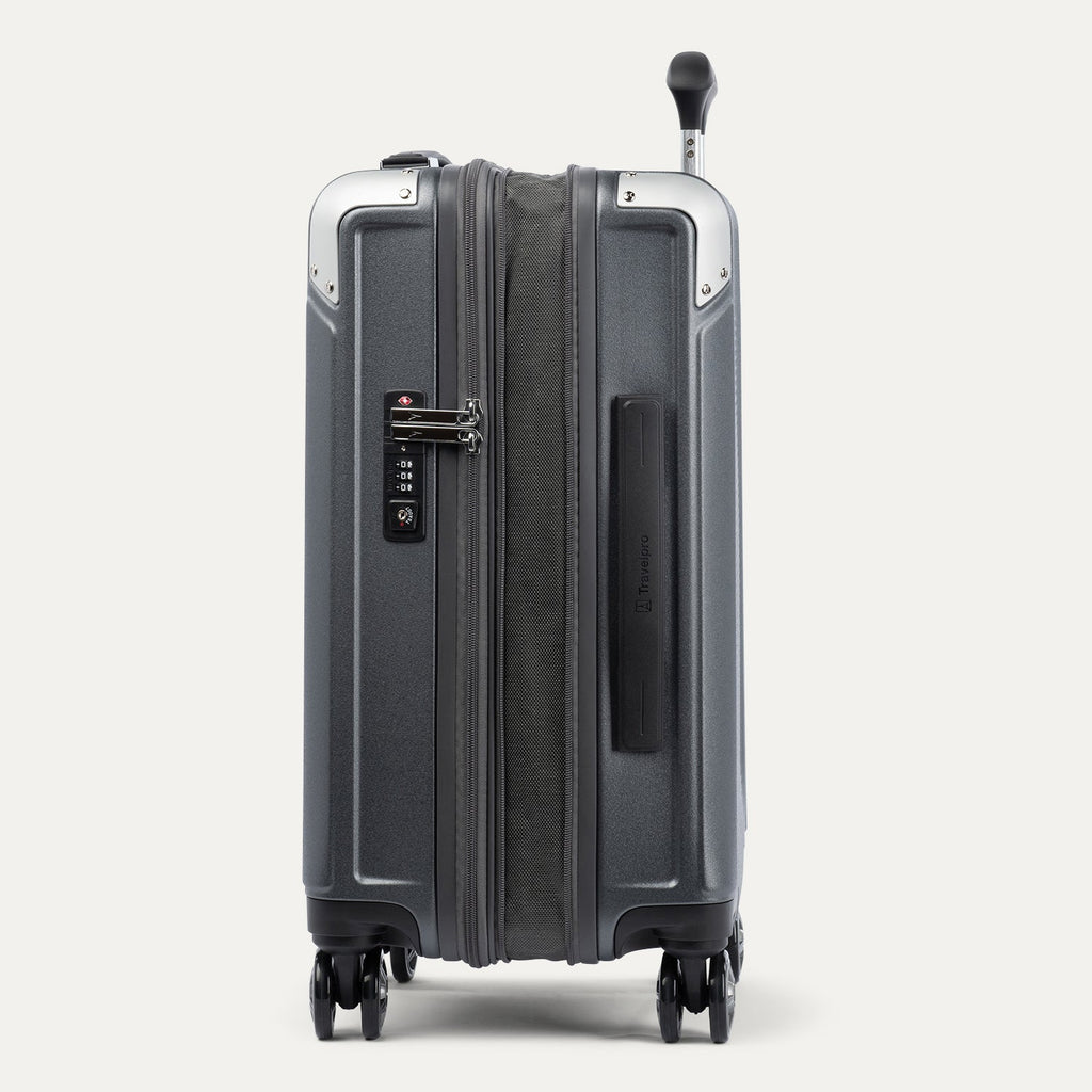 Side view of expanded gray suitcase with combination lock on a white background