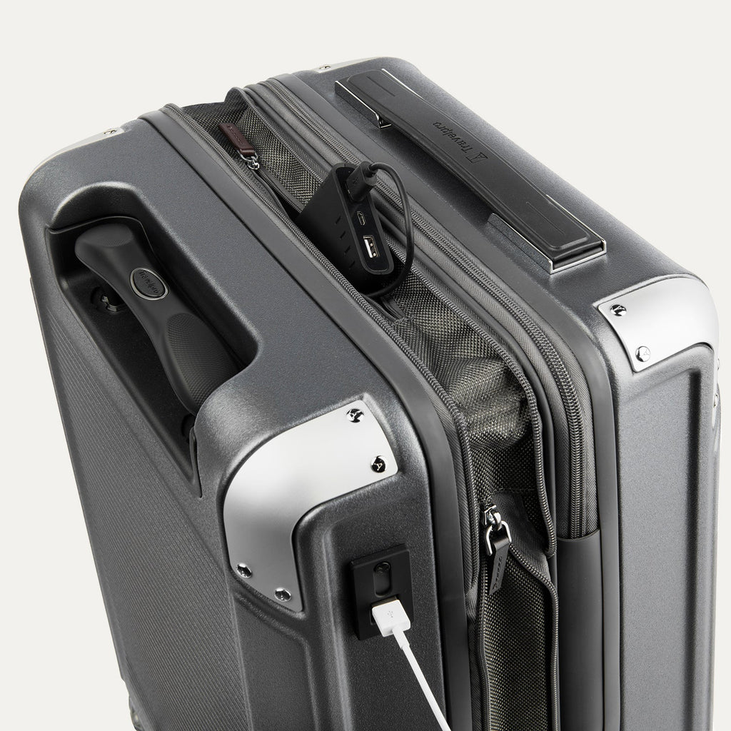 Close-up of a gray suitcase with USB cable outlet on a white background.