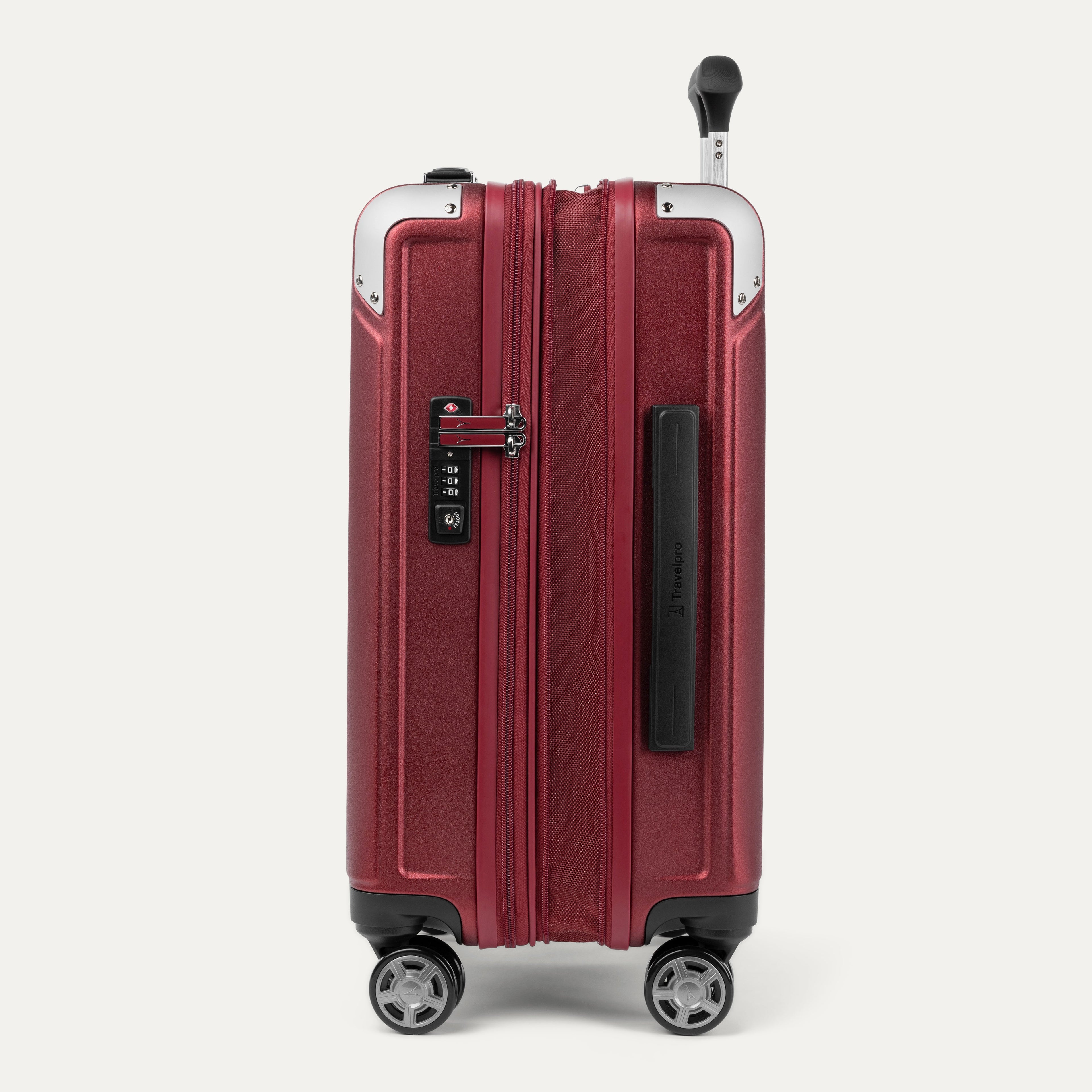 Side view of expanded red suitcase with combination lock on a white background