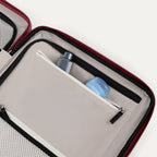 Close-up of a open suitcase interior compartment with toiletries inside.