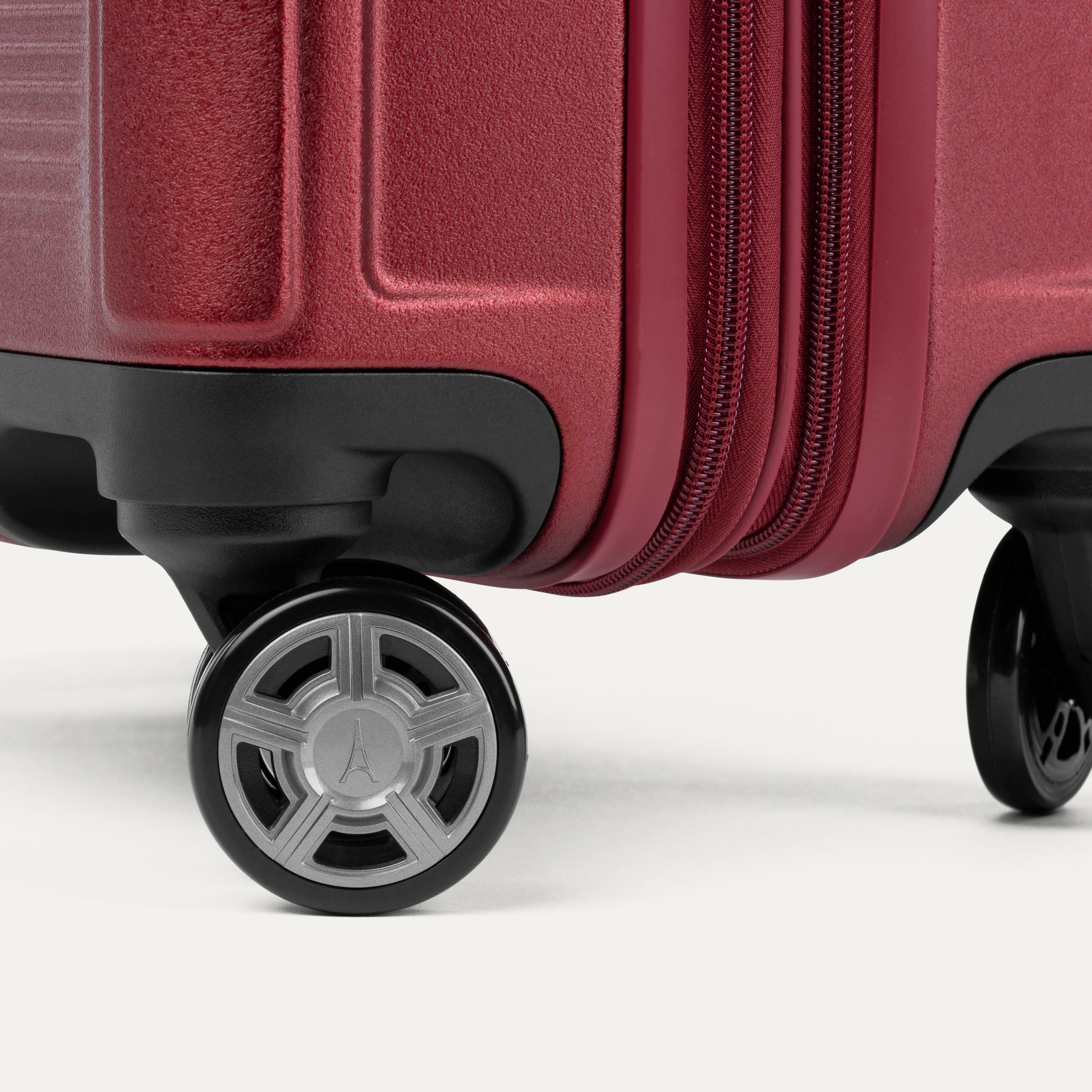 Close-up of a red suitcase wheel on a white background