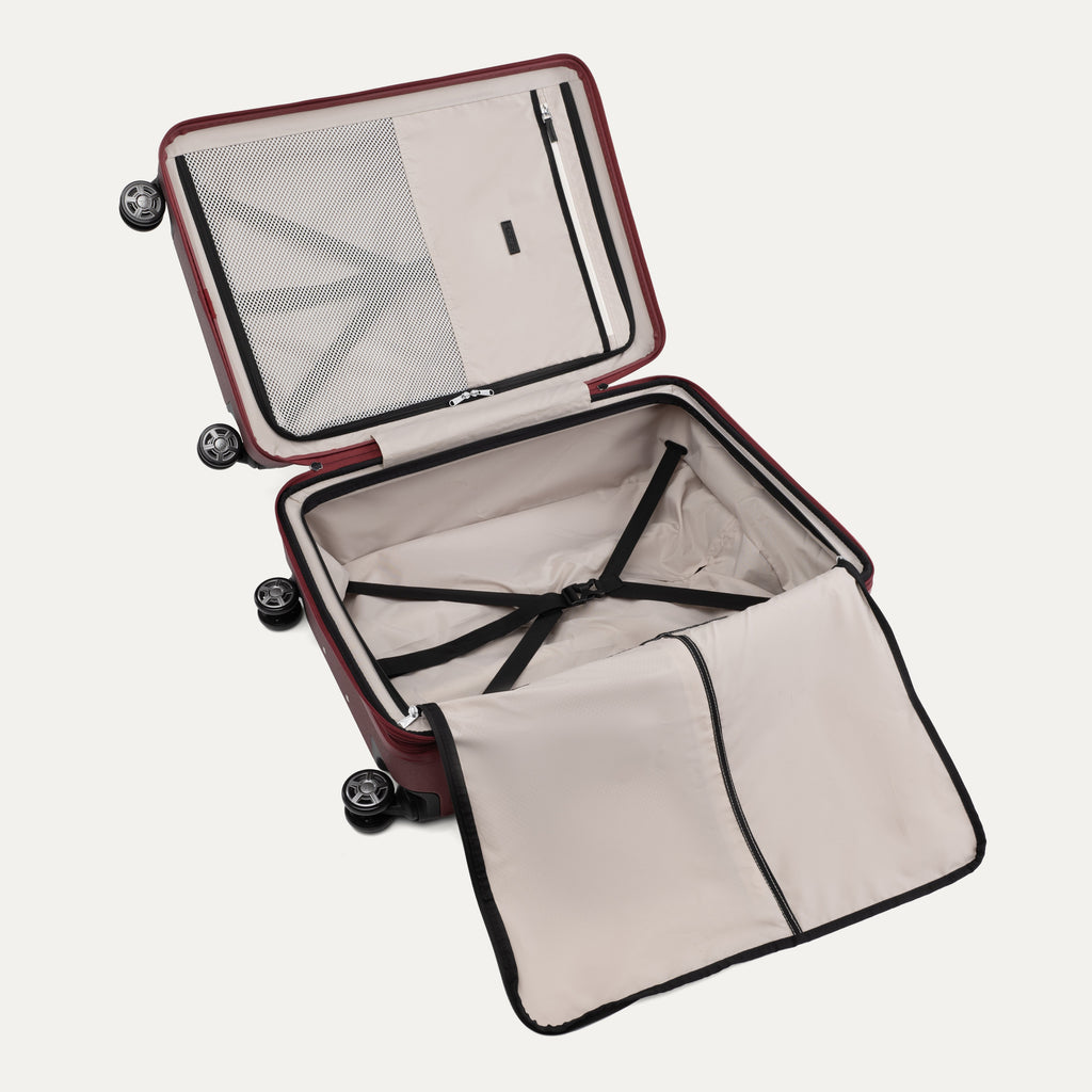 Open suitcase with black wheels on a white background