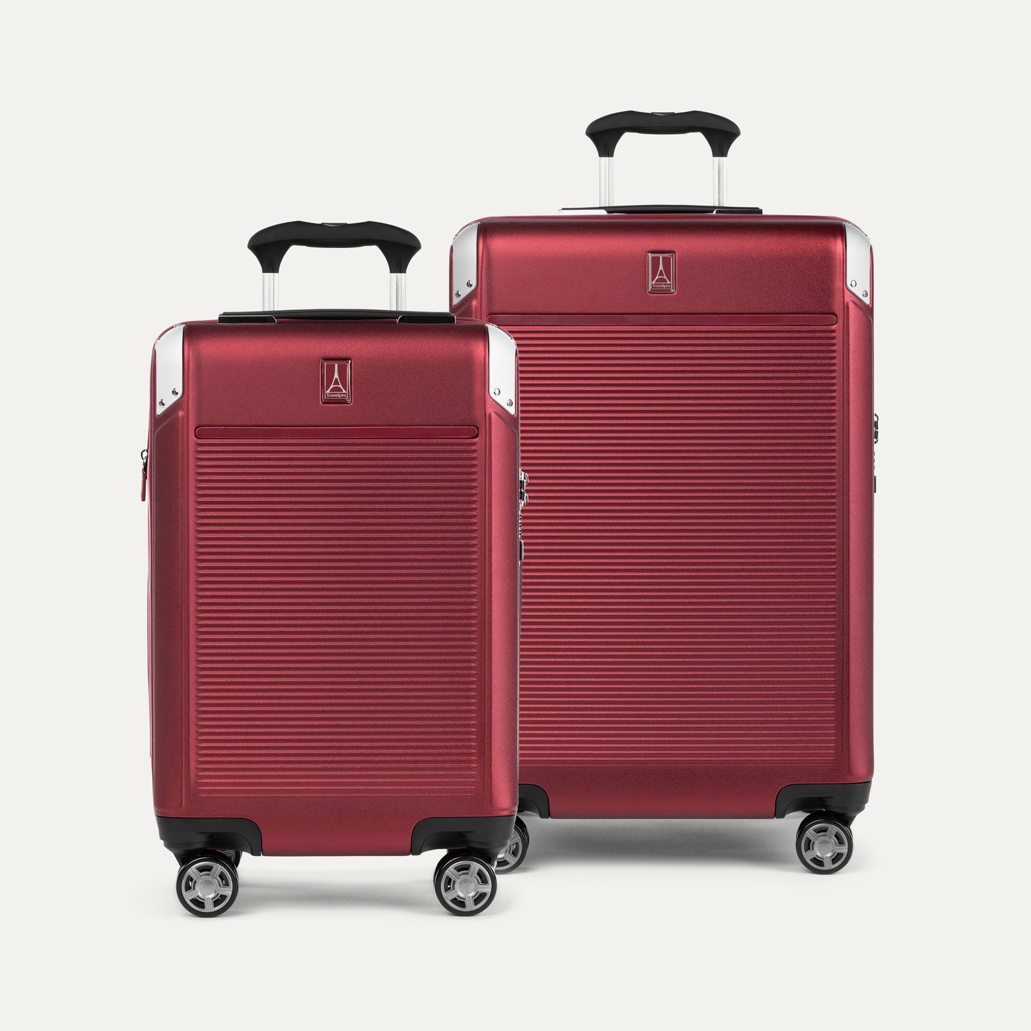 Two red suitcases with black handles on a white background