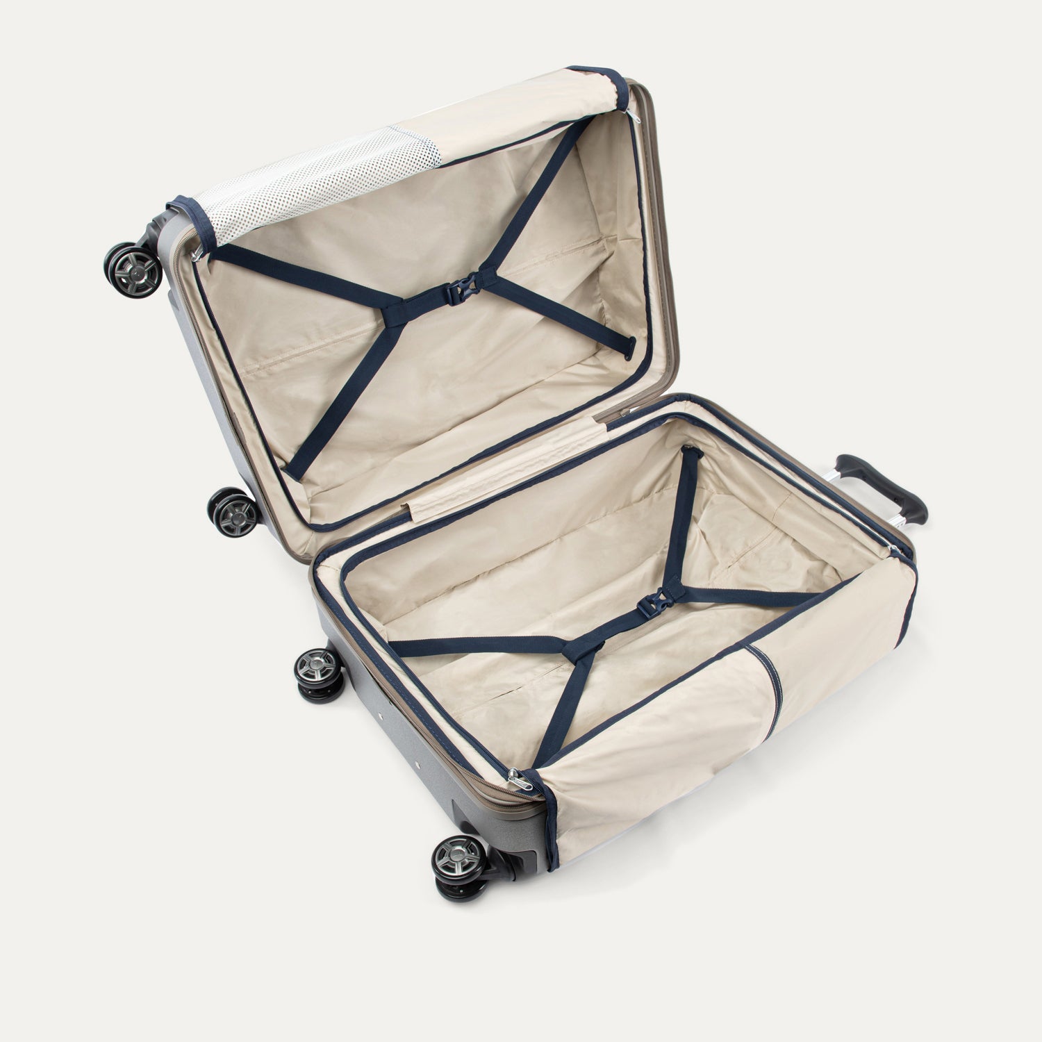 Open suitcase with beige interior and black straps on a white background. 