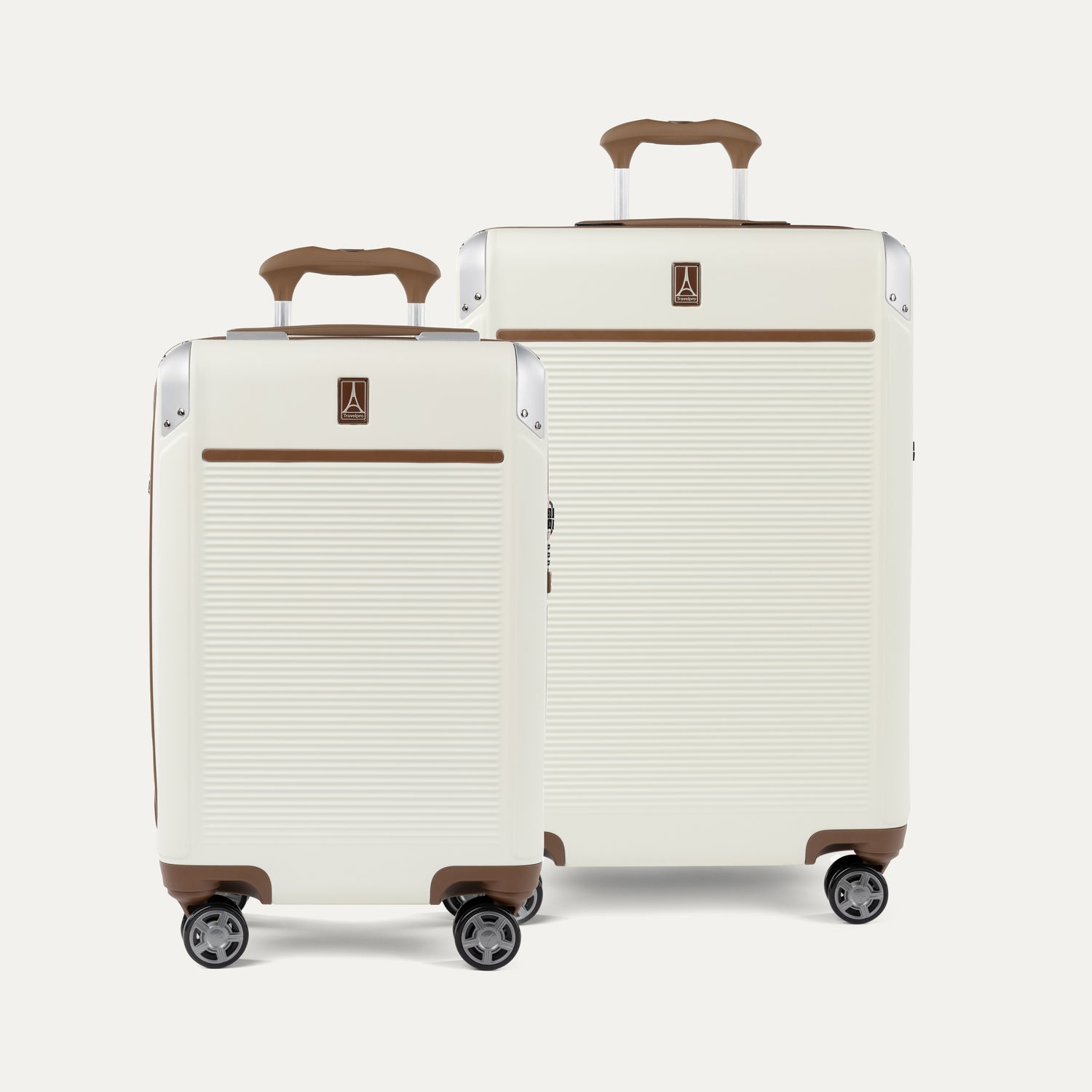 A set of two Platinum Elite hardside spinner suitcases in cream white , including a carry-on and a medium check-in size, featuring brown leather trim and aluminum corner protectors.