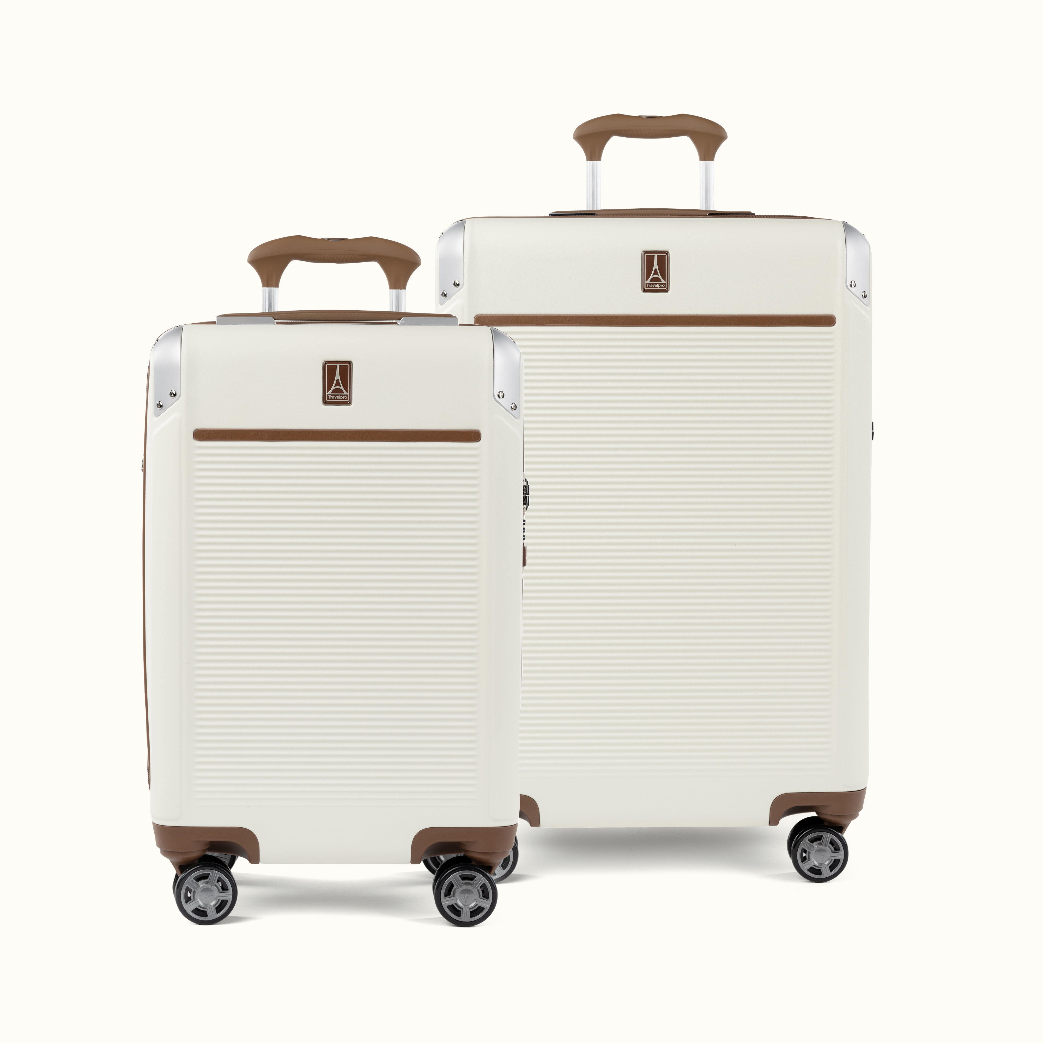 A set of two Platinum Elite hardside spinner suitcases in cream white , including a carry-on and a medium check-in size, featuring brown leather trim and aluminum corner protectors.