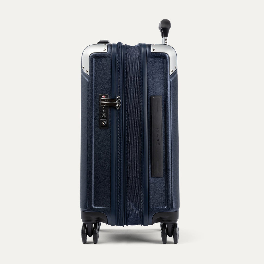 Side view of expanded navy blue suitcase with combination lock on a white background