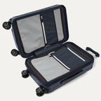 Open navy suitcase with black wheels on a white background