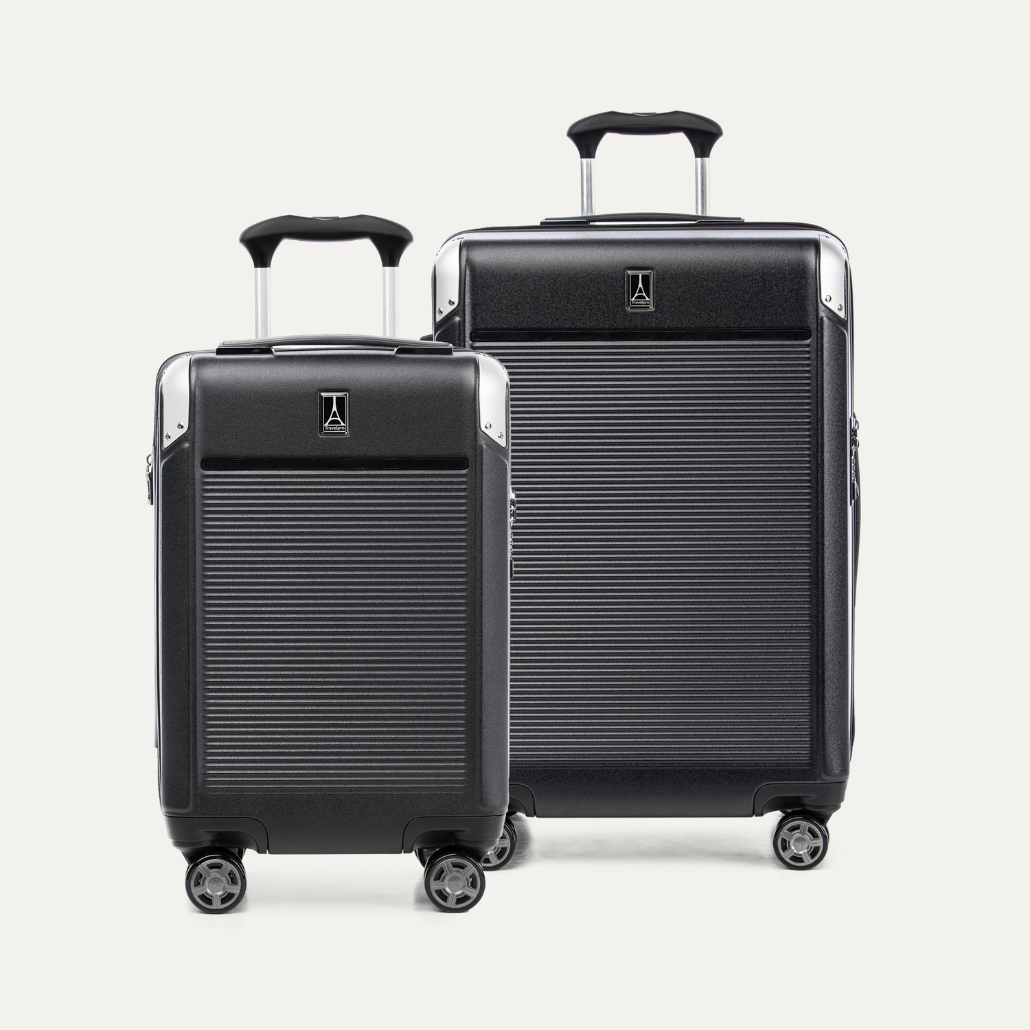Two black suitcases of different sizes on a white background