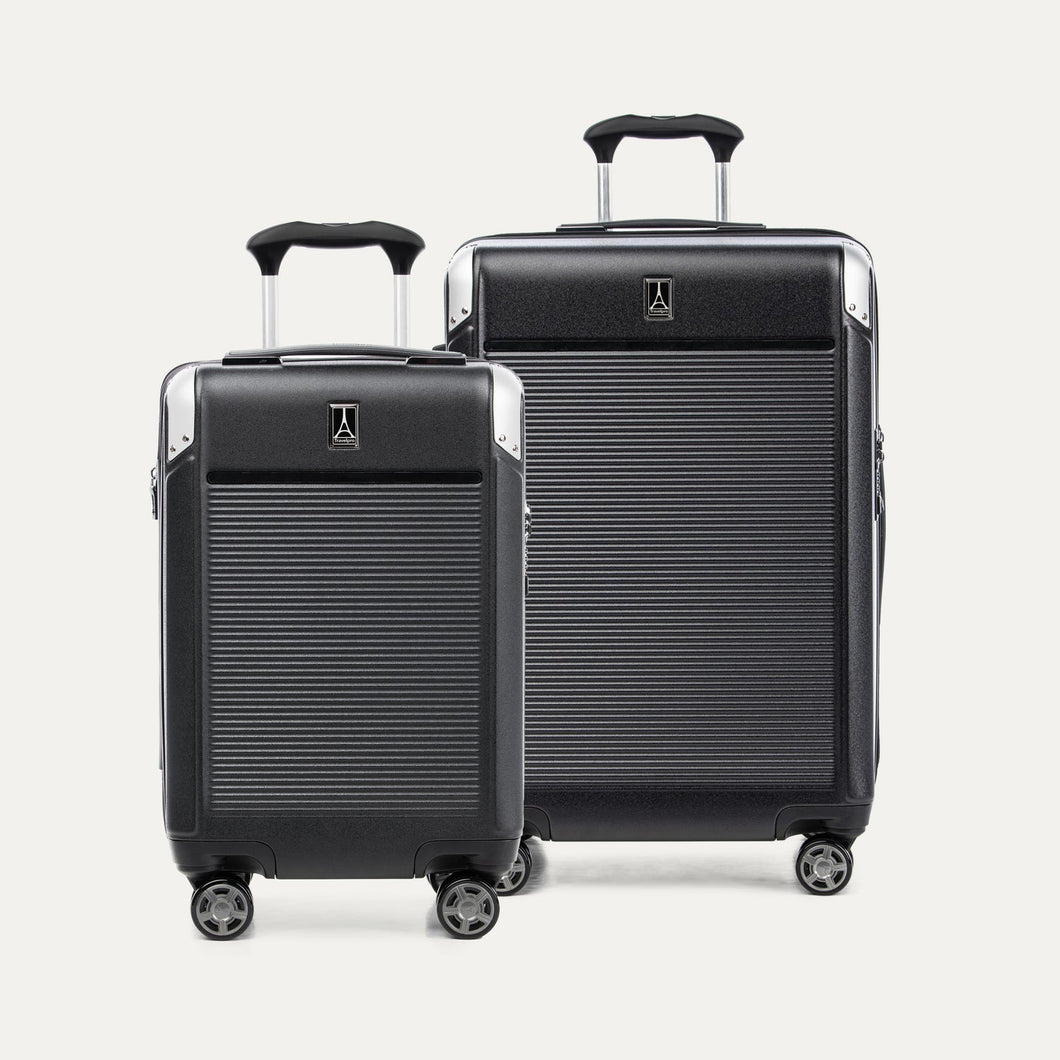 Two black suitcases of different sizes on a white background