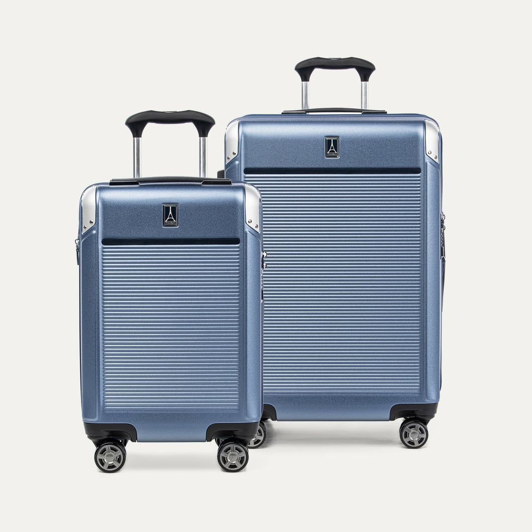 Two blue suitcases with a textured surface on a white background