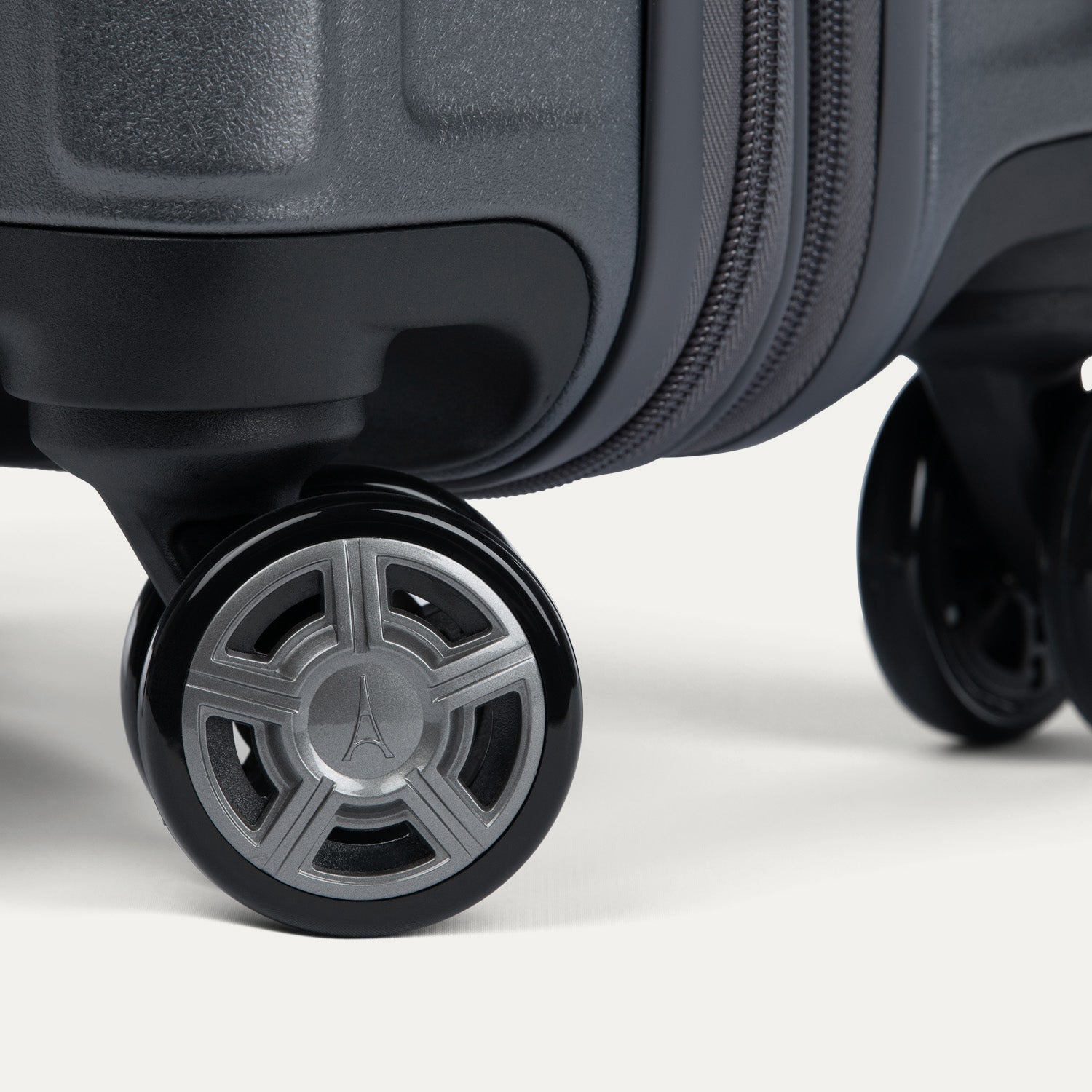 Close-up of a suitcase wheel on a white background