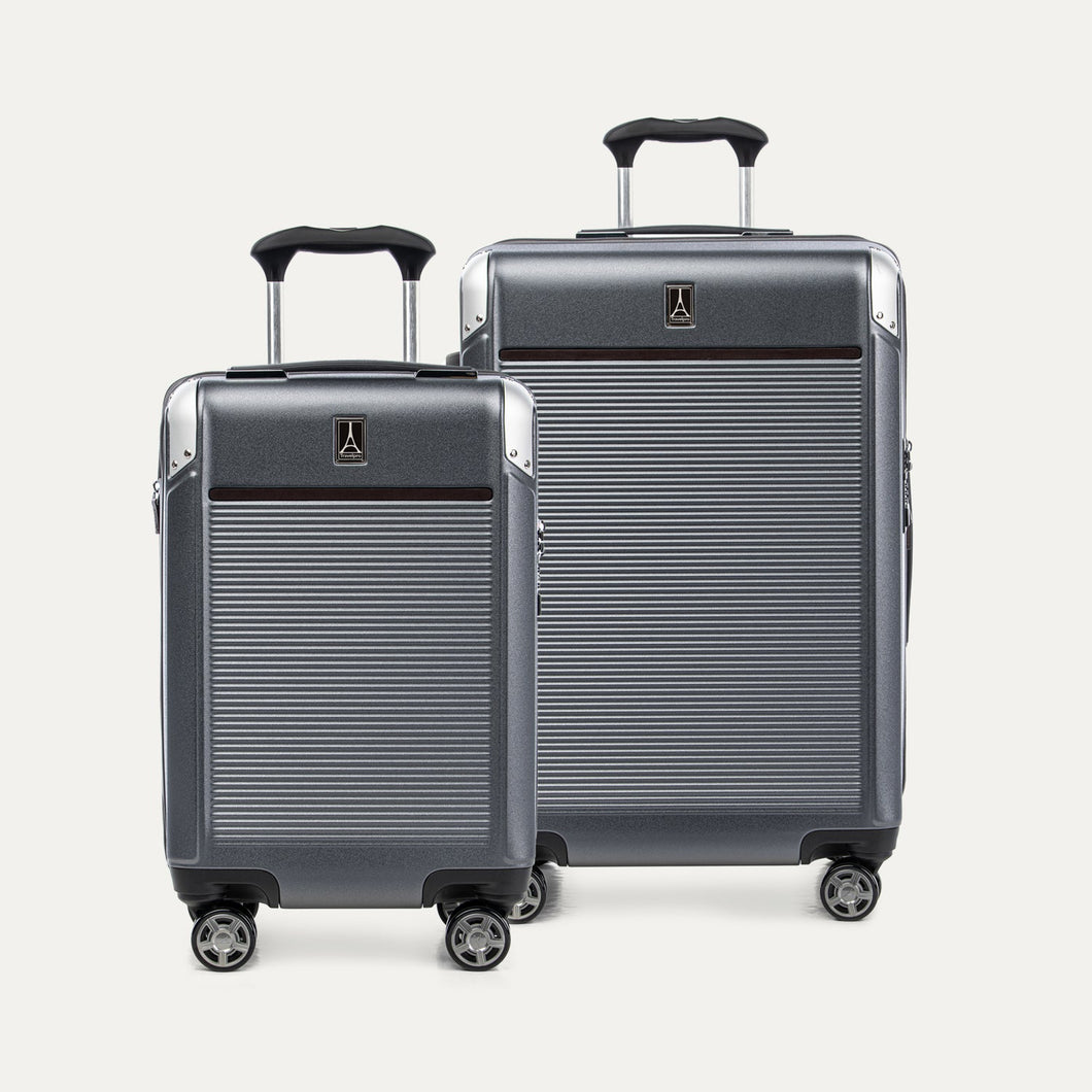 Two gray suitcases with visible travelpro logo on a white background