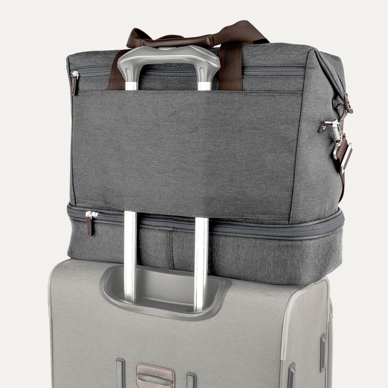 Grey weekender with a grey rear strap over suitcase handle on a white background