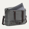 Grey weekender with a laptop shown in the interior padded sleeve compartment on white background 