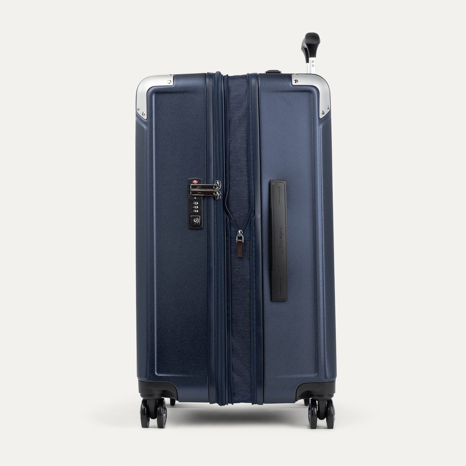 Side view of true navy suitcase expanded and with a tsa lock on a white background
