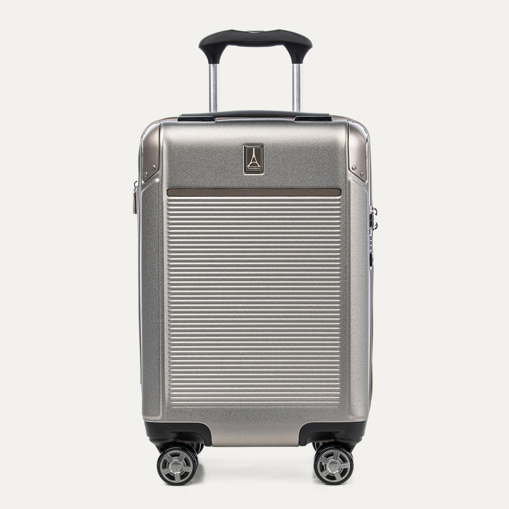 Front view of Travelpro Platinum Elite Compact Carry-On Hardside Spinner in Metallic Sand, featuring a durable aluminum shell and extension handle.
