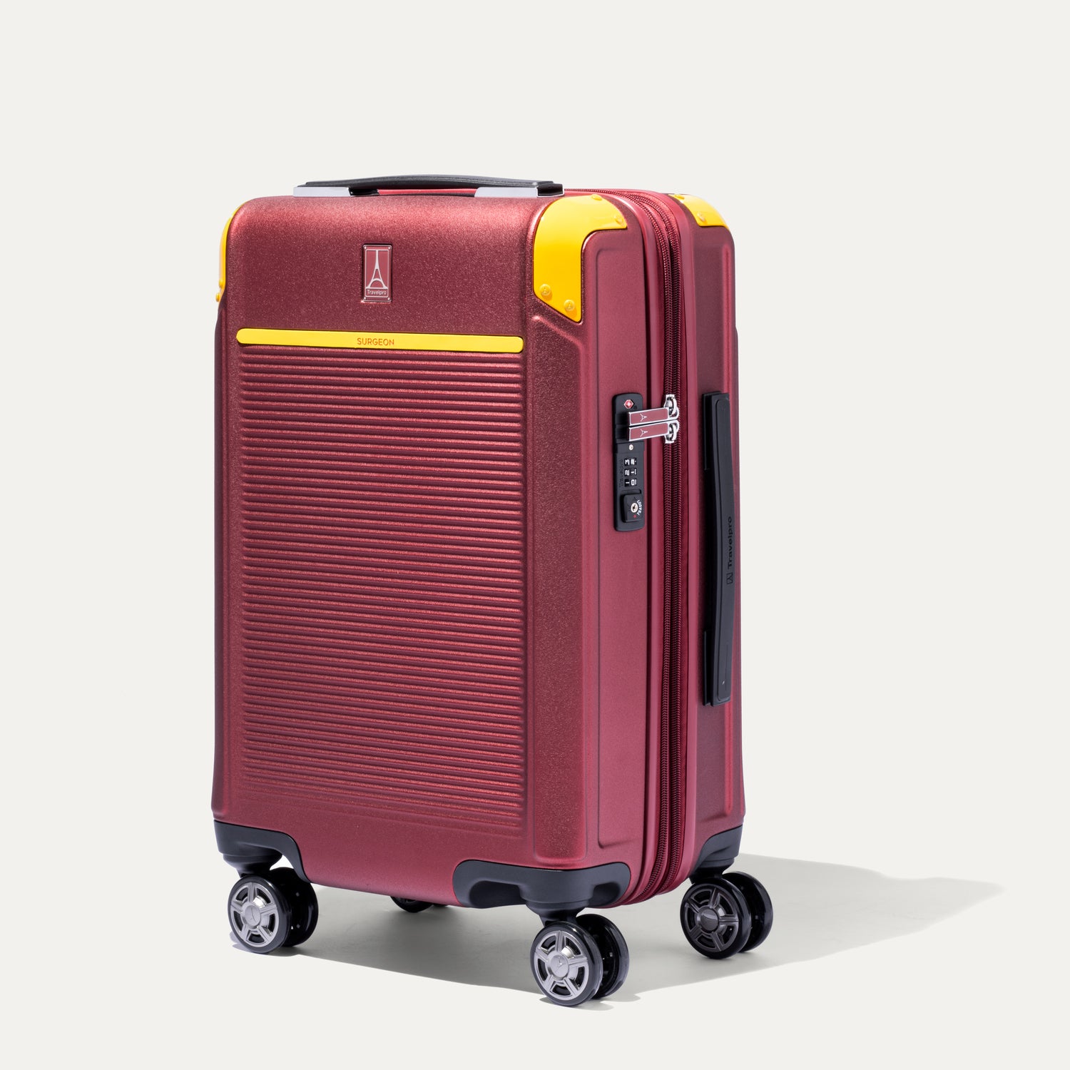 Front view of Travelpro x Surgeon Check-In Spinner in Daring Red with yellow corner guards and textured front panel.
