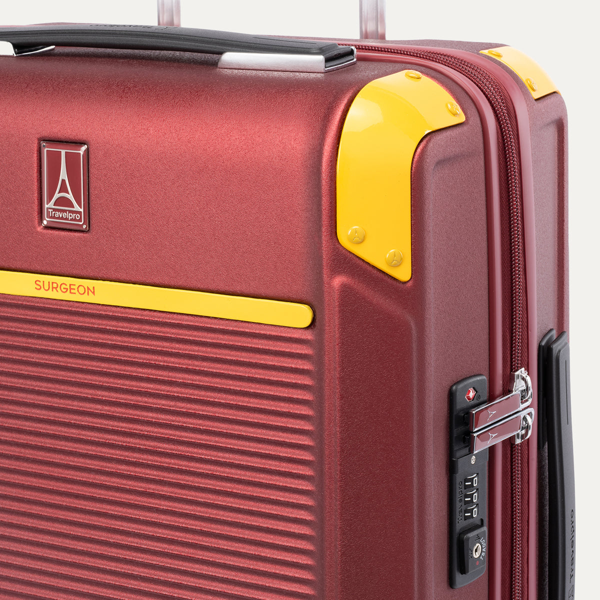 Detail view of Travelpro x Surgeon Check-In Spinner in Daring Red, highlighting logo, yellow trim, and integrated TSA Approved Lock.
