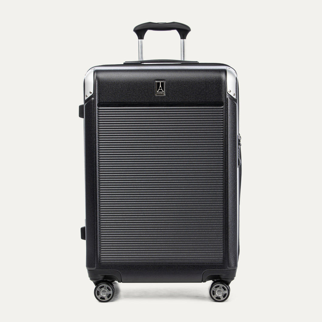 Front view of Travelpro Platinum® Elite Hardside Medium Check-In Expandable Spinner in Black, featuring textured polycarbonate shell with chrome corner guards.
