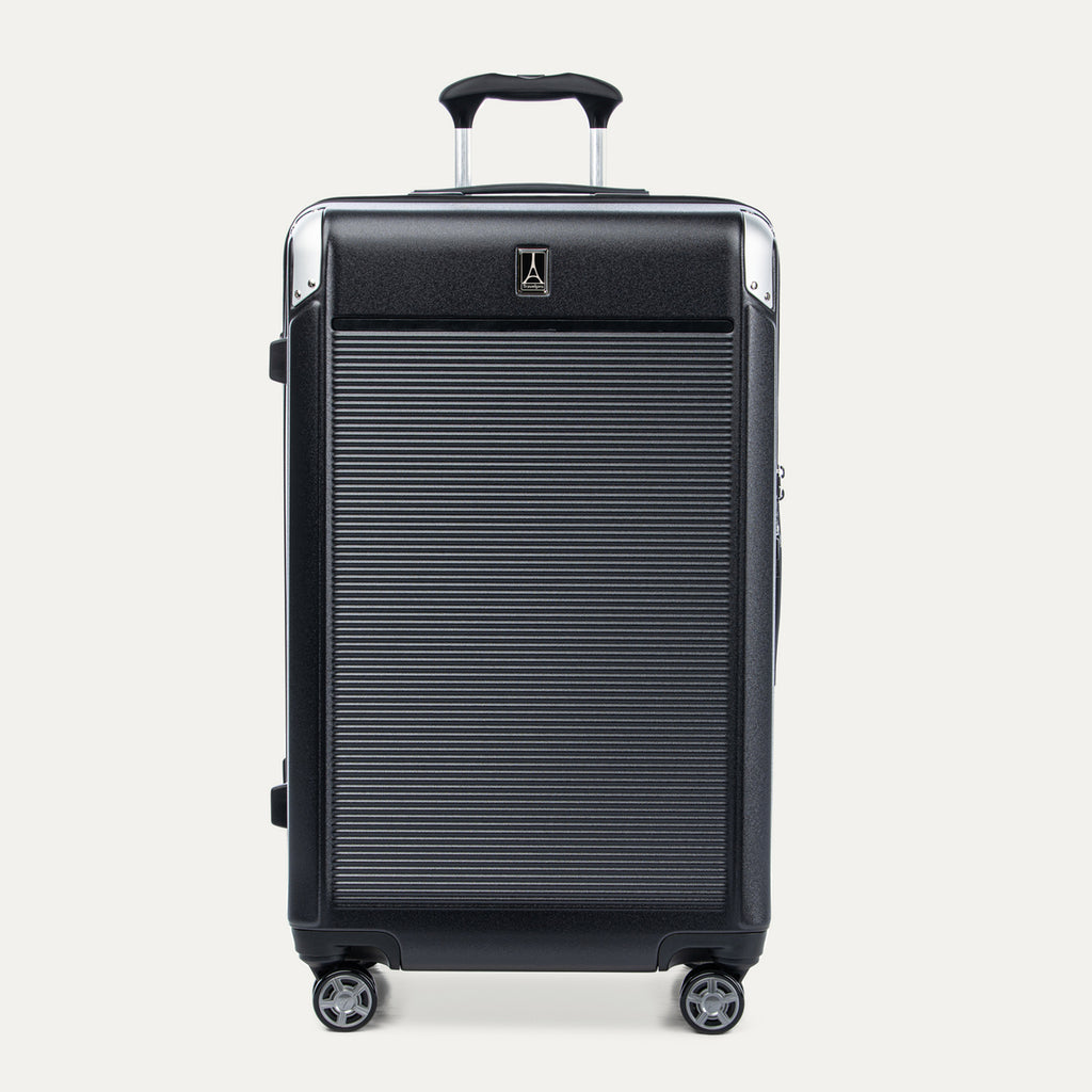 Front view of Travelpro Platinum® Elite Hardside Large Check-In Expandable Spinner in Jet Black, featuring grooved polycarbonate shell with chrome corner armor.
