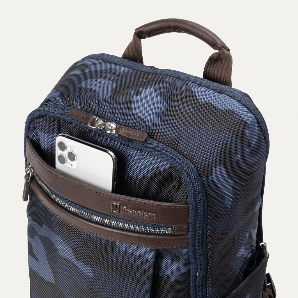 Close-up view of Travelpro Platinum Elite Slim Backpack in Navy Camouflage with phone in QuickSlip front pocket.
