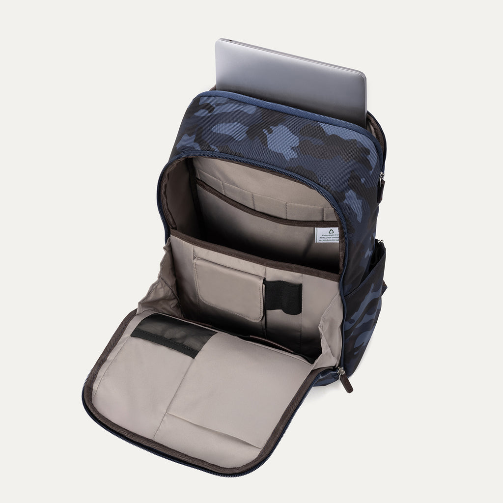 Interior view of Travelpro Platinum Elite Slim Backpack in Camouflage, showing padded laptop sleeve and multiple organizer pockets.
