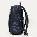 Side view of Travelpro Platinum Elite Slim Backpack in Navy Camouflage with zippered side pocket and padded shoulder strap.
