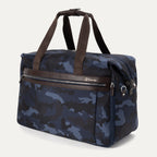 Platinum® Elite Soft Duffel in Camouflage, shown at an angle to highlight its structured shape, dual top handles, side attachment points, and front zippered pocket with leather trim.
