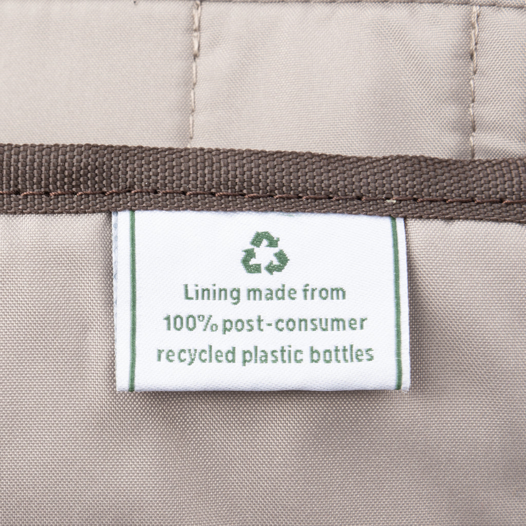 Close-up of label indicating lining made from 100% post-consumer recycled plastic bottles.
