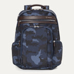A blue camouflage pattern Travelpro Platinum Elite Business Backpack with leather accents, multiple compartments, and YKK zippers.