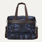 Front view of Travelpro Platinum Elite Drop-Bottom Weekender in Navy Camouflage with dual carry handles and zippered front pocket.
