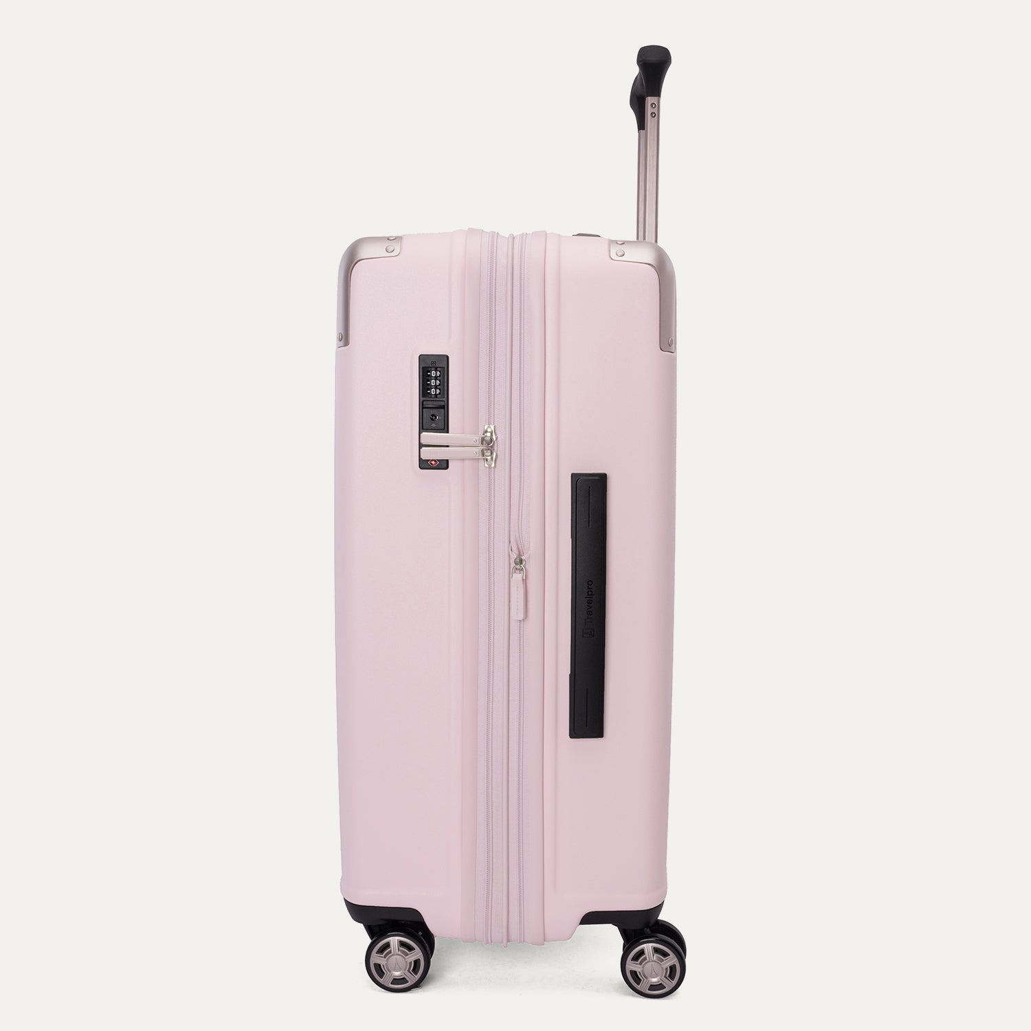 Side view of the Travelpro Platinum Elite Medium Check-In Hardside Spinner in Powder Pink, featuring a durable polycarbonate shell with polished aluminum corner armor, an extended telescopic handle, and multi-directional wheels against a clean off-white background.
