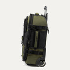 side view of the olive black bold by travelpro carry-on expandable rollaboard suitcase standing vertically, showing its durable army green fabric accent panels, padded side carry handle, exterior compression straps with buckles, a high-performance corner-mounted wheel, and the extended telescoping handle.