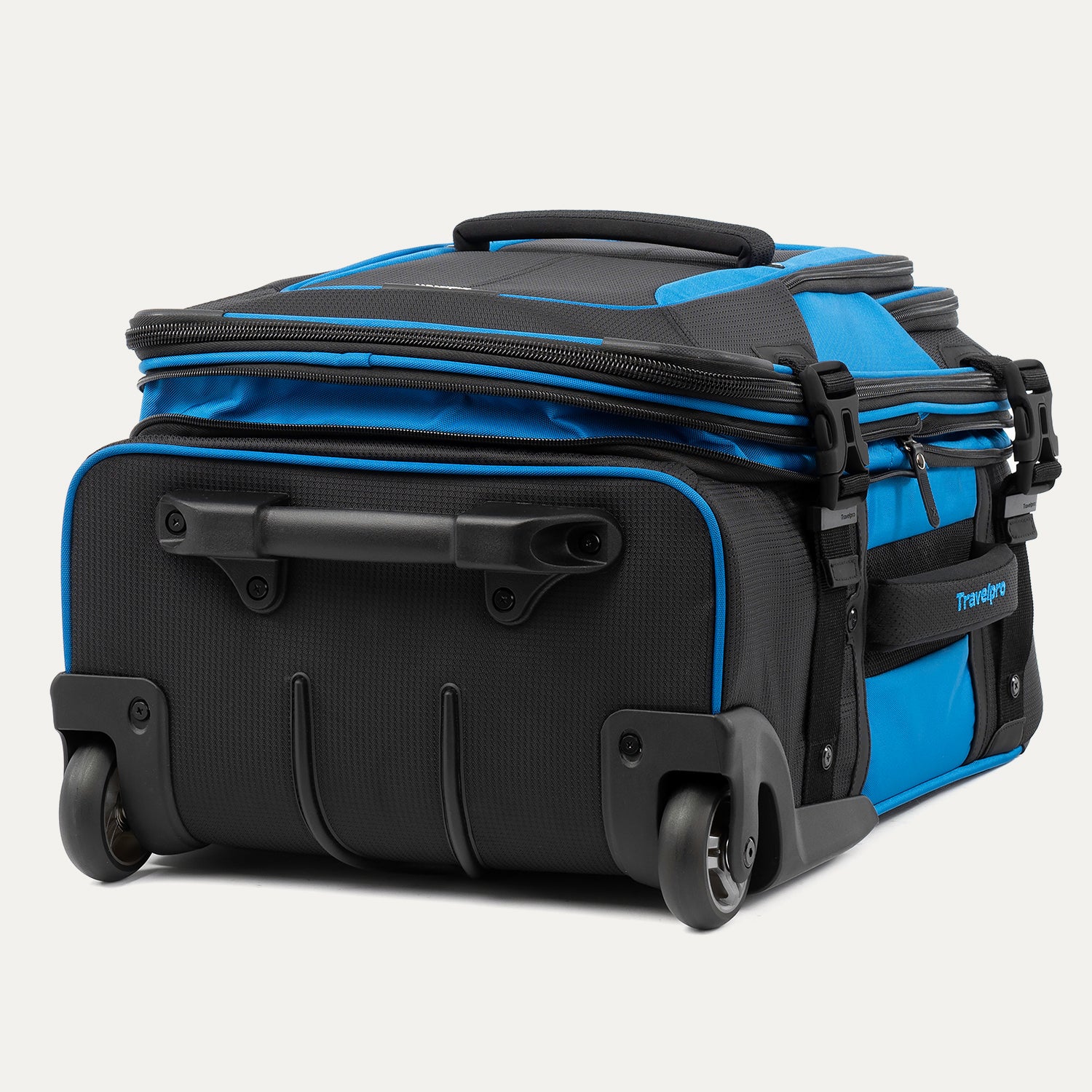 bottom view of the Travelpro® BOLD™ by Travelpro® carry-on in Blue Black, highlighting its durable inline wheels, reinforced bottom handle, and rugged base designed 