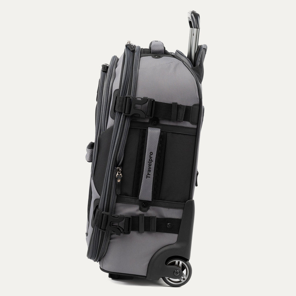 Side view of gray and black Bold™ by Travelpro® Rollaboard® showing compression straps, wheel housing, and telescoping handle.
