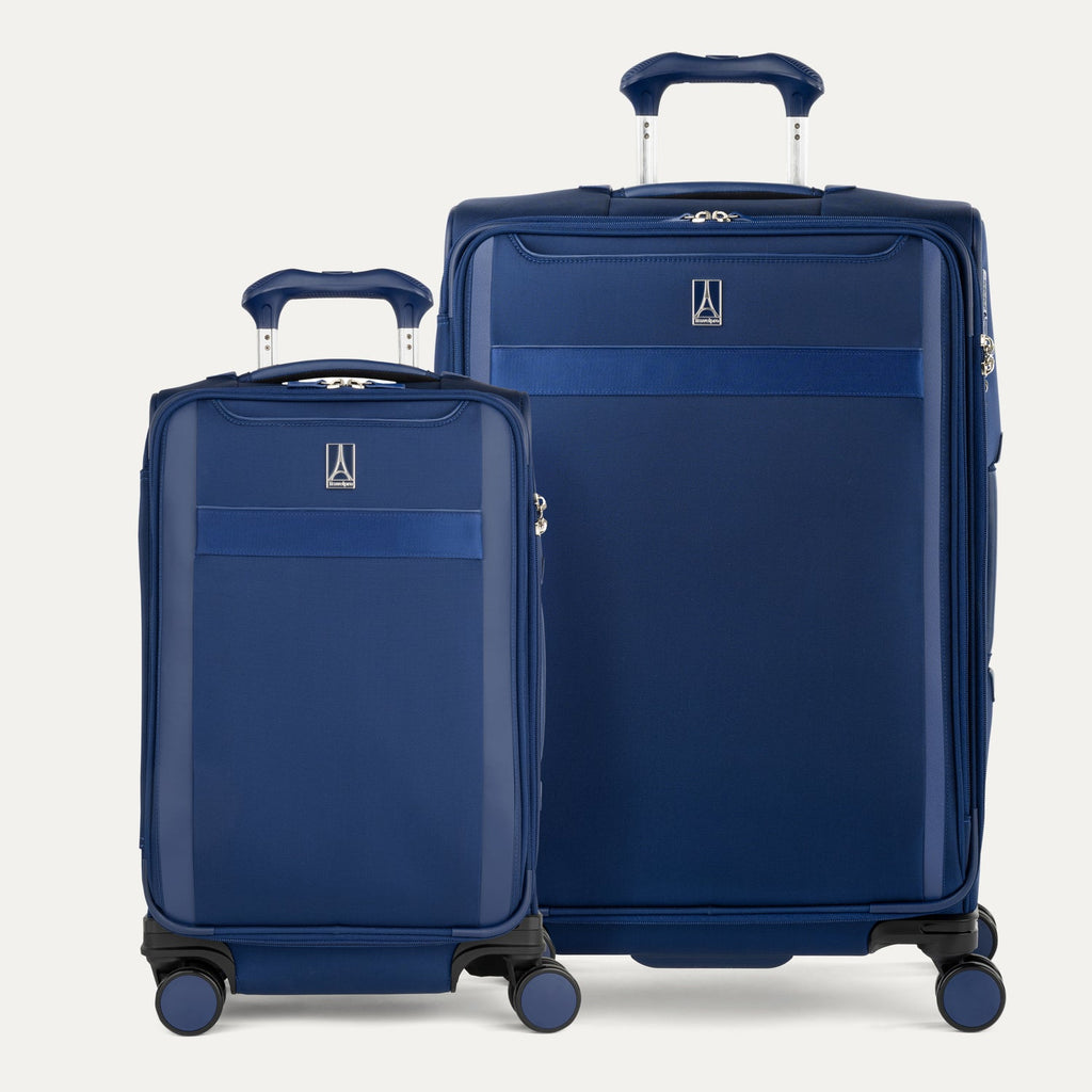 Two blue suitcases of different sizes on a white background