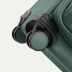 Green suitcase with black wheels on a white background