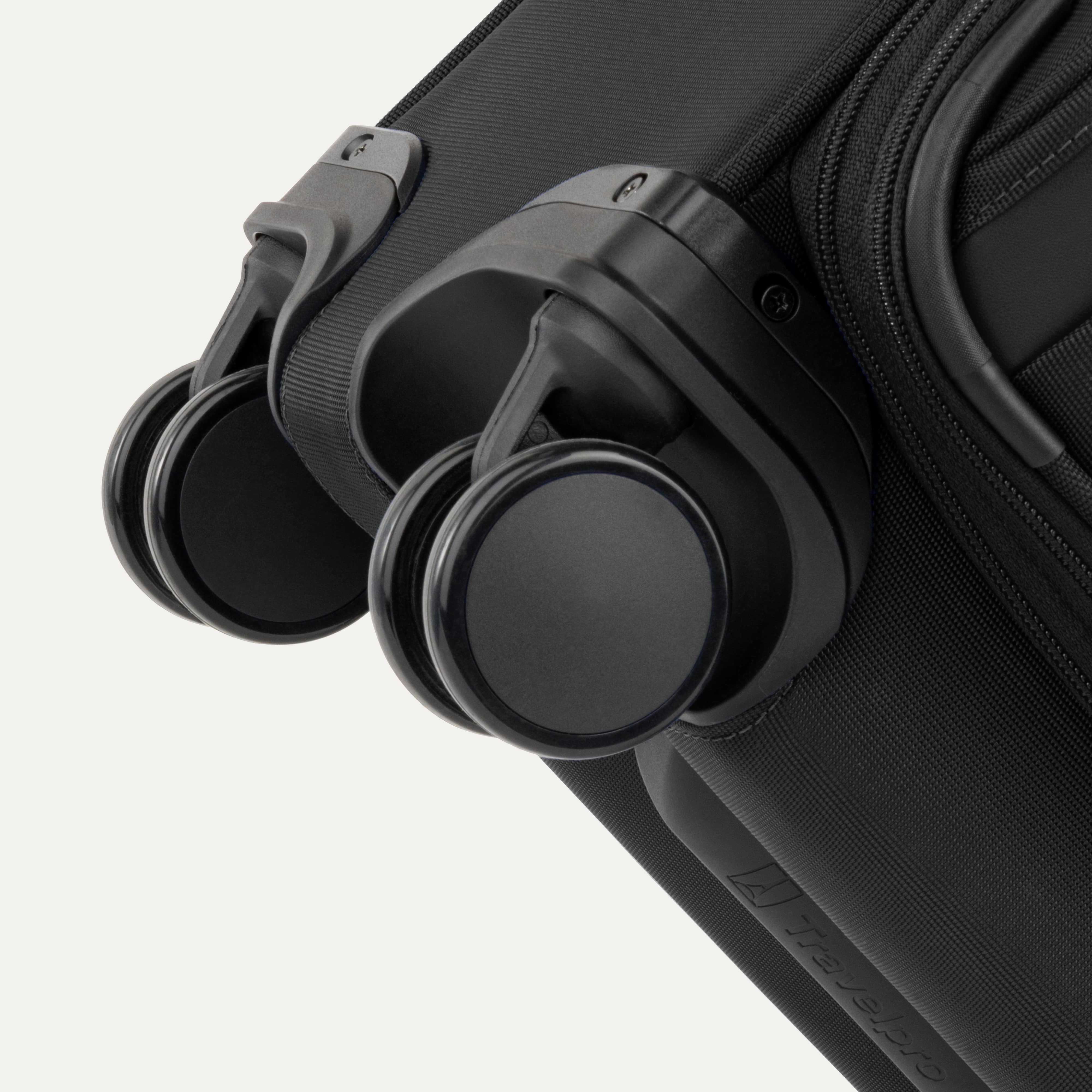Close-up of a black suitcase with black wheels on a white background