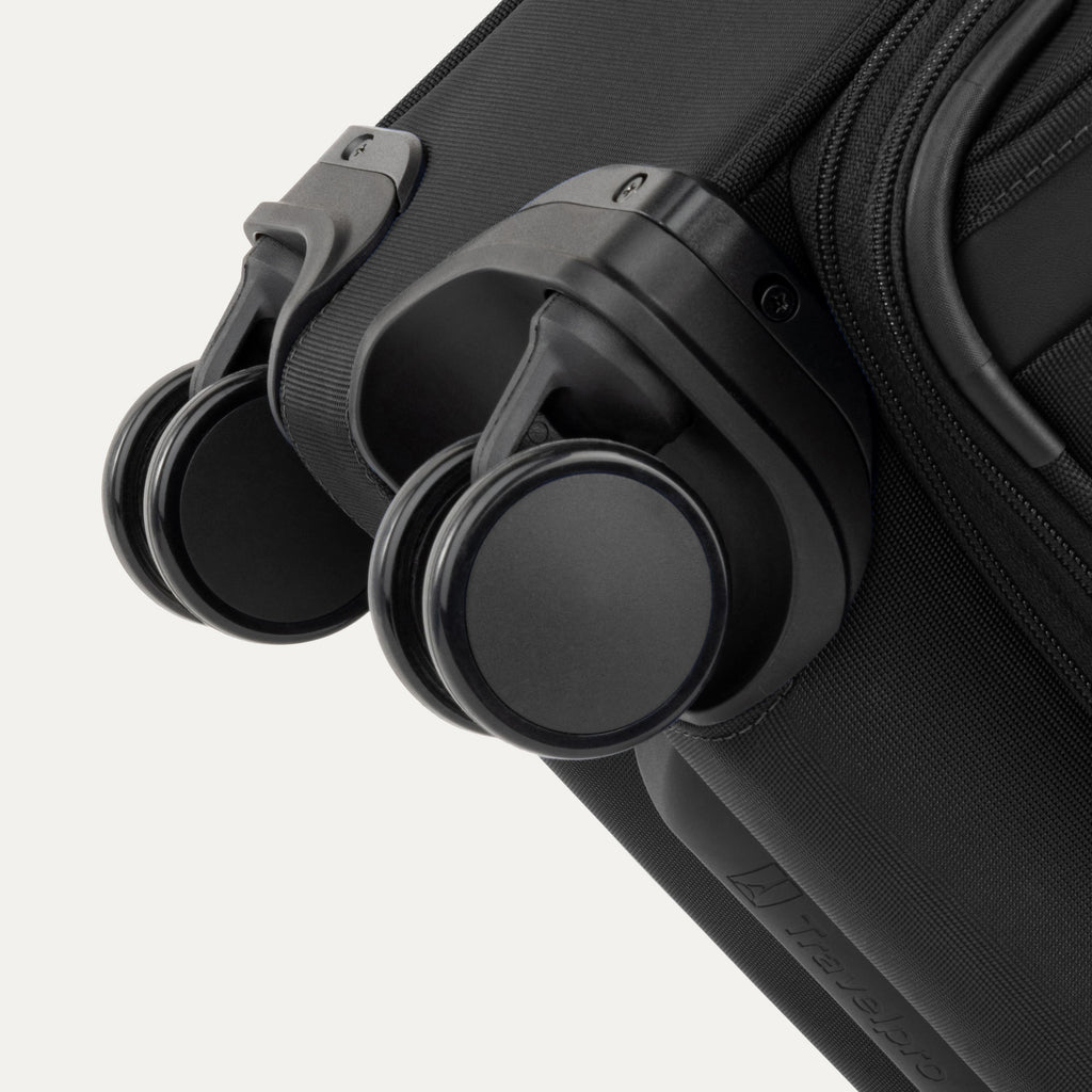 Close-up of a black suitcase with black wheels on a white background