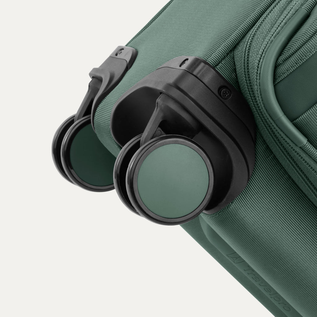 Green suitcase with black wheels on a white background