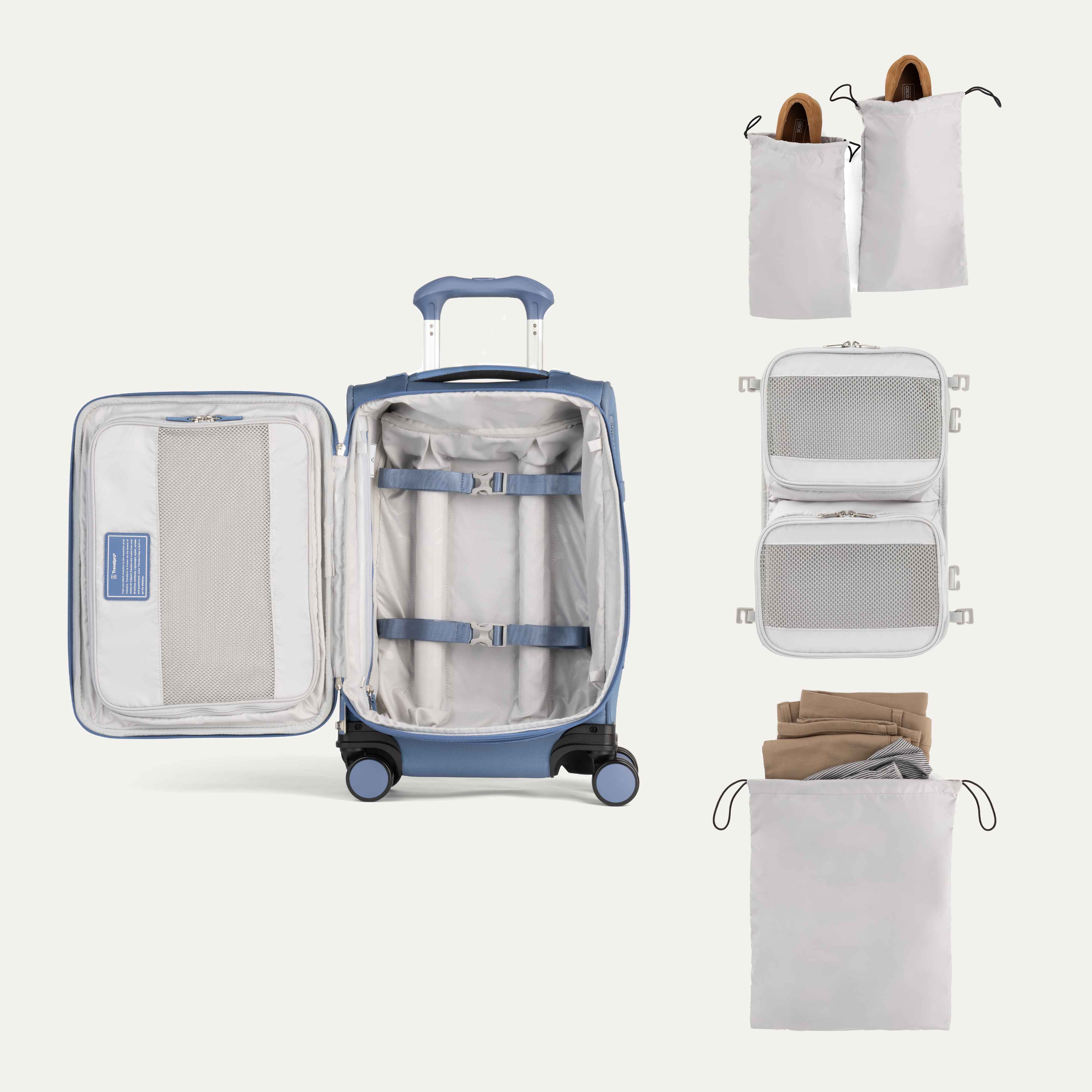 Open suitcase with travel packing cubes and clothes on a white background