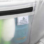 Interior lining tag on a Travelpro suitcase, highlighting construction from 100% post-consumer recycled plastic bottles.
