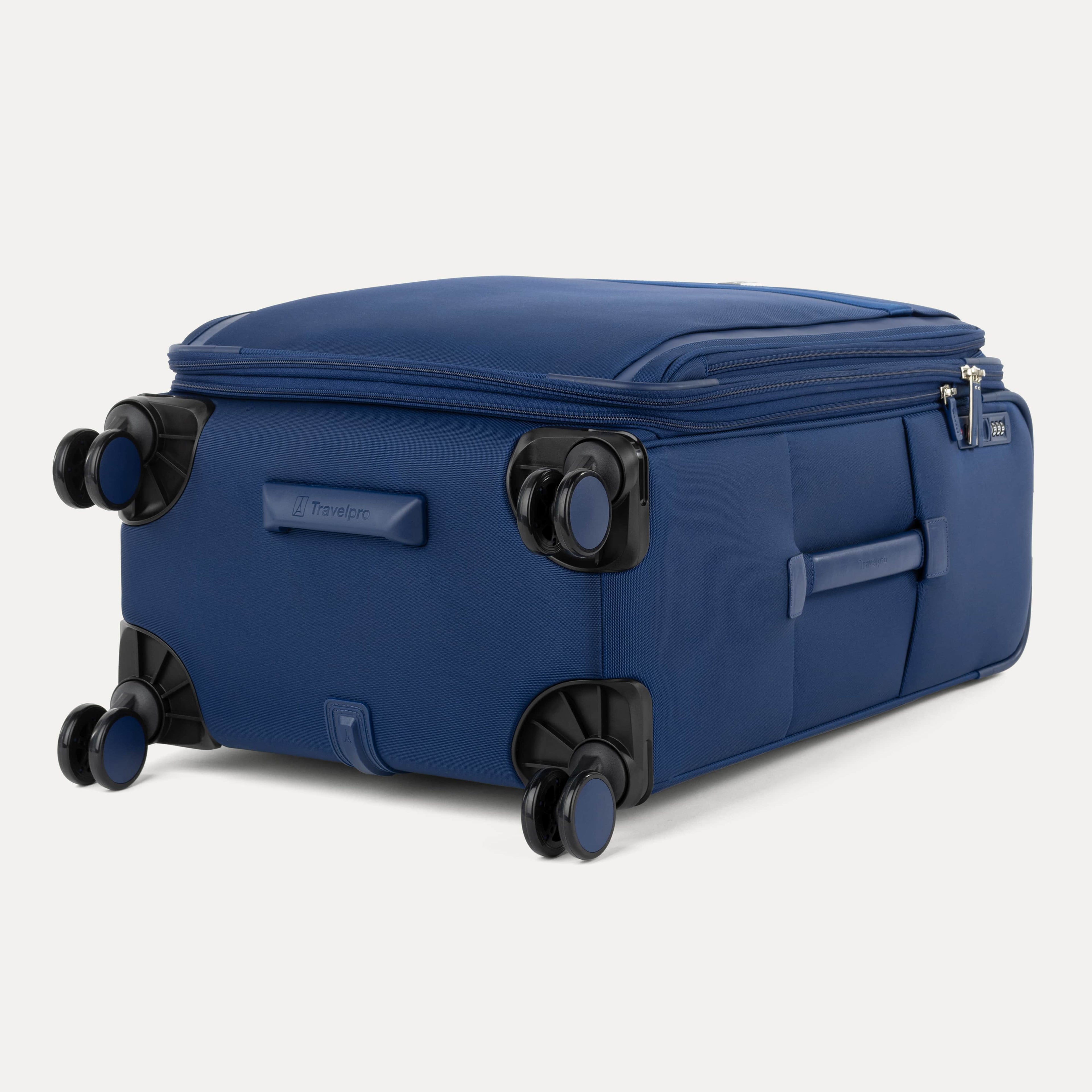 Bottom view of Travelpro Versapack Spinner in Estate Blue, showcasing durable wheel housing and smooth-gliding 360° Spinner Wheels.
