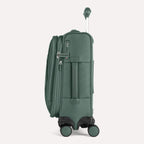 Side view of Travelpro VersaPack®+ Compact Carry-On Spinner in Desert Sage Green, featuring an expandable zipper, TSA-approved lock, and padded side carry handle with extended handle.