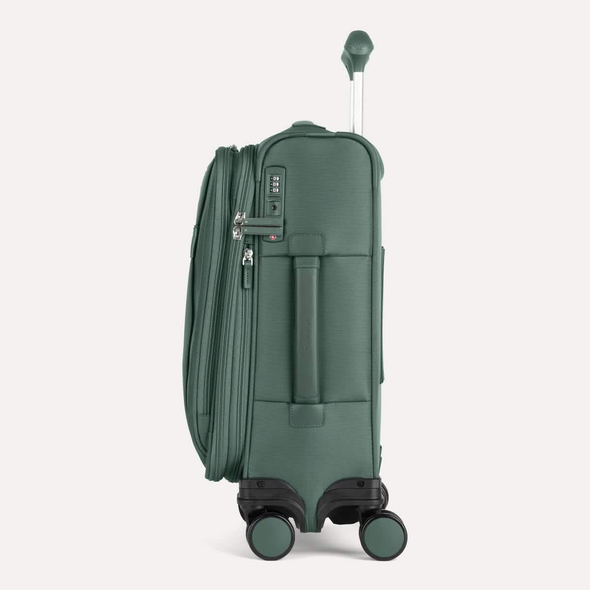 Side view of Travelpro VersaPack®+ Compact Carry-On Spinner in Desert Sage Green, featuring an expandable zipper, TSA-approved lock, and padded side carry handle with extended handle.