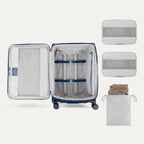 Water Resistant Interior of Blue VersaPack+ Medium Check-In Luggage Spinner with Removable Organizers and Laundry Bag