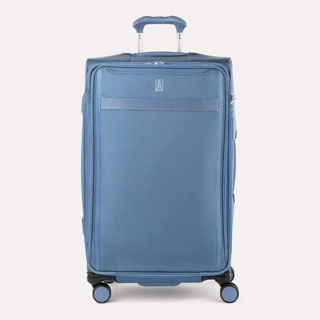 Front-facing Travelpro VersaPack+ Large Check-In Spinner in Elemental Blue, featuring smooth 360° spinner wheels and a textured handle.
